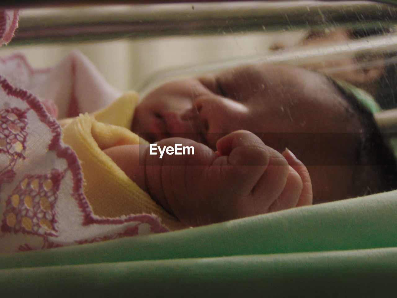 Close-up of cute baby sleeping in crib