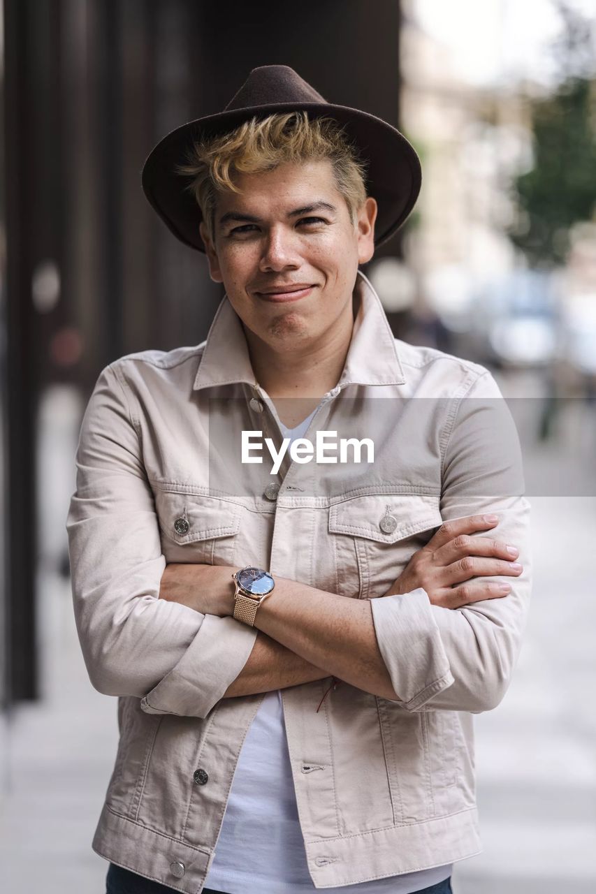 Portrait of young man wearing hat standing outdoors