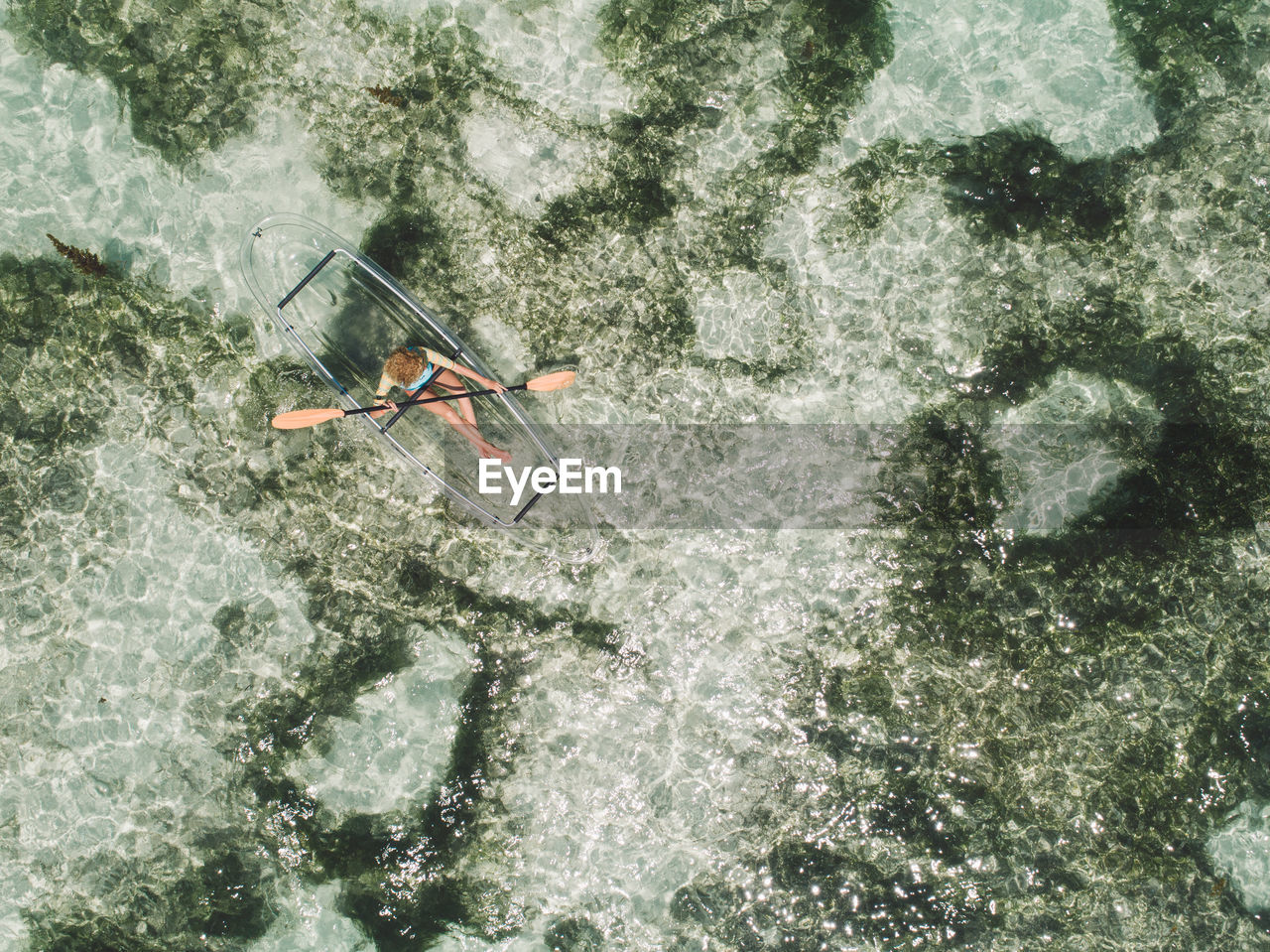 Aerial view of woman kayaking in sea