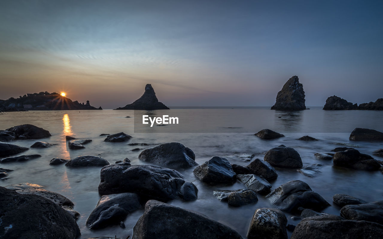 Scenic view of sea against sky at sunset