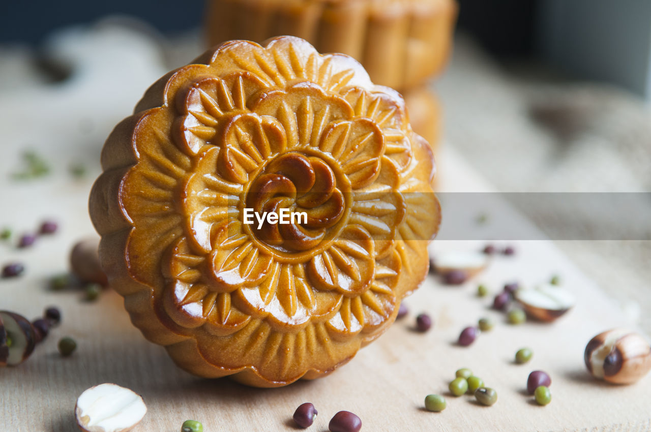 Close-up of moon cakes with seeds on cutting board