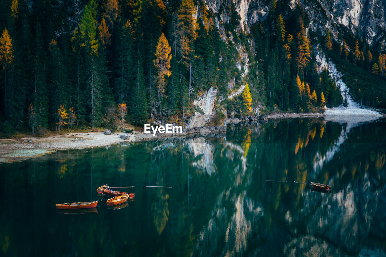 Boats in lake against mountains