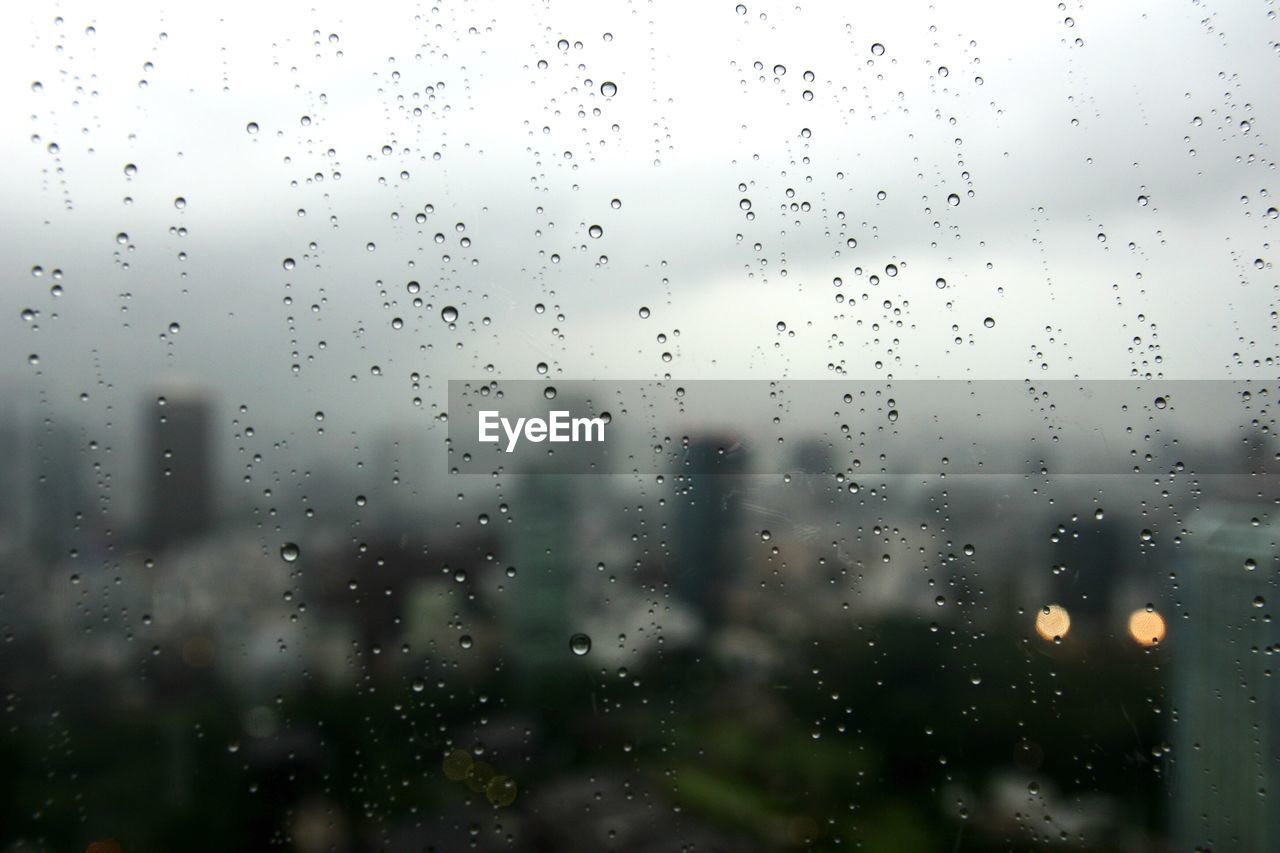 Full frame shot of wet glass window during rainy season