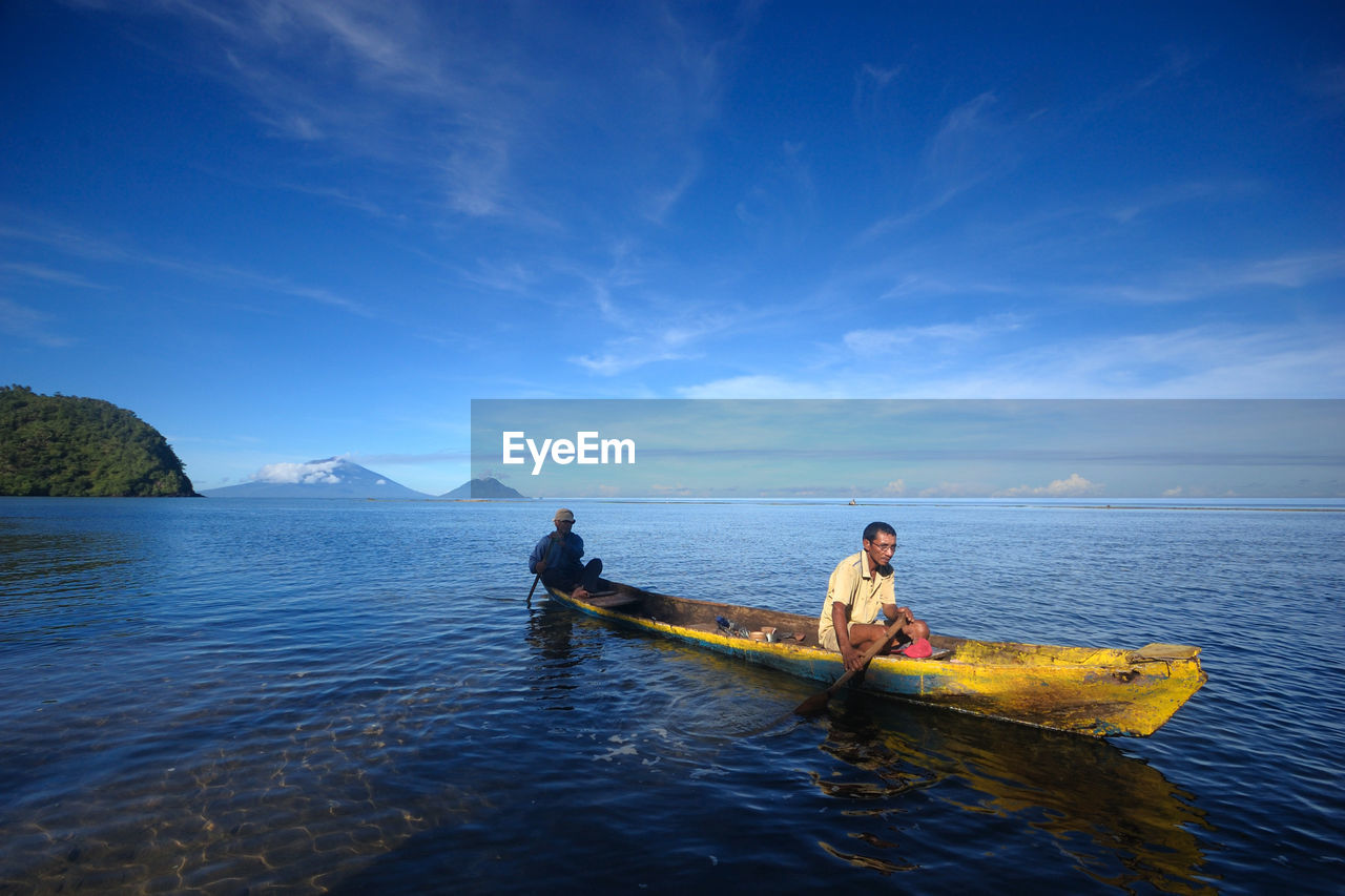 PEOPLE ENJOYING IN SEA AGAINST SKY