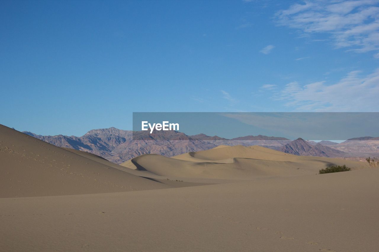 Scenic view of desert against clear blue sky