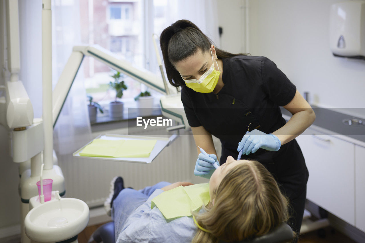 Female dentist with patient in office