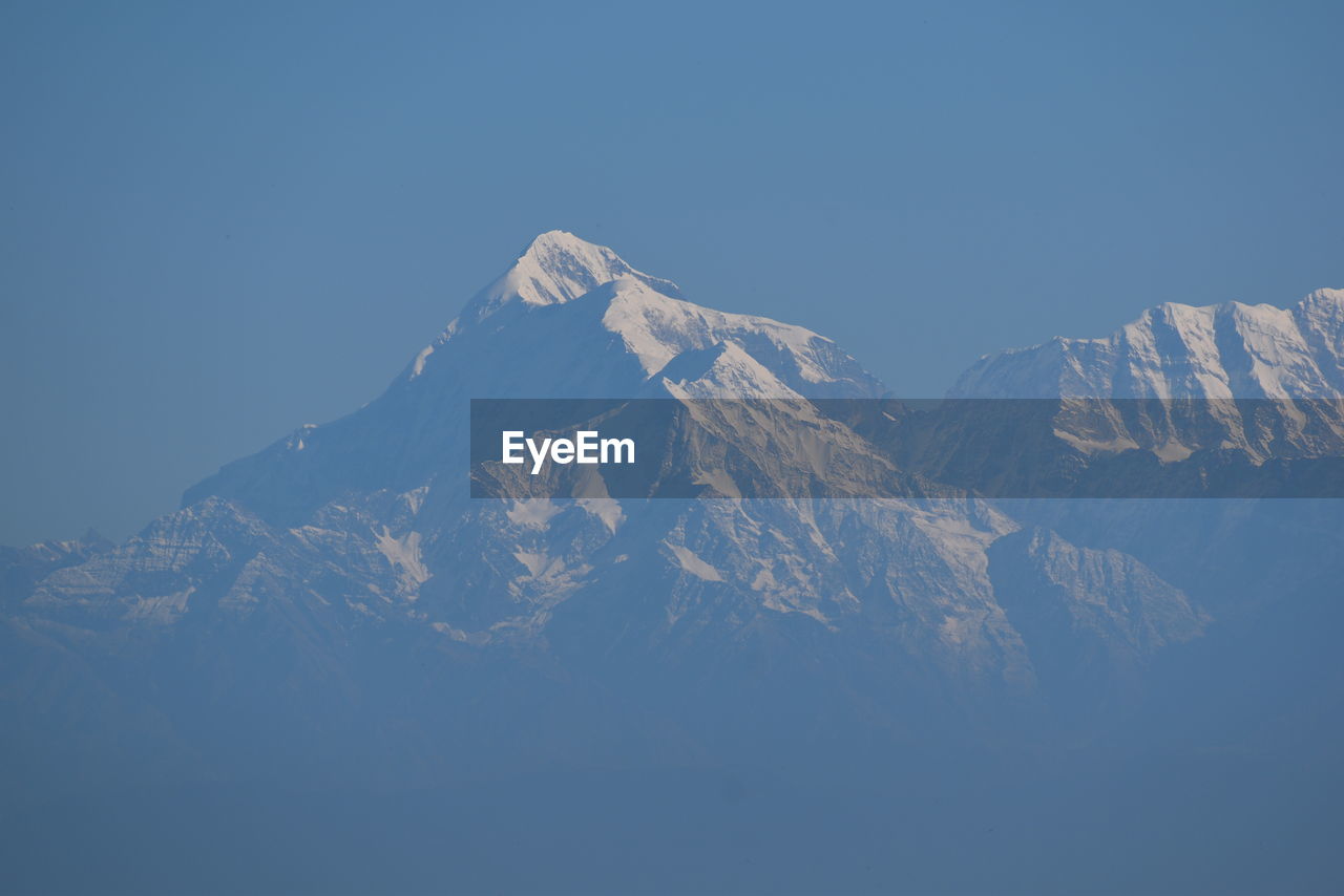 SCENIC VIEW OF SNOWCAPPED MOUNTAINS AGAINST BLUE SKY