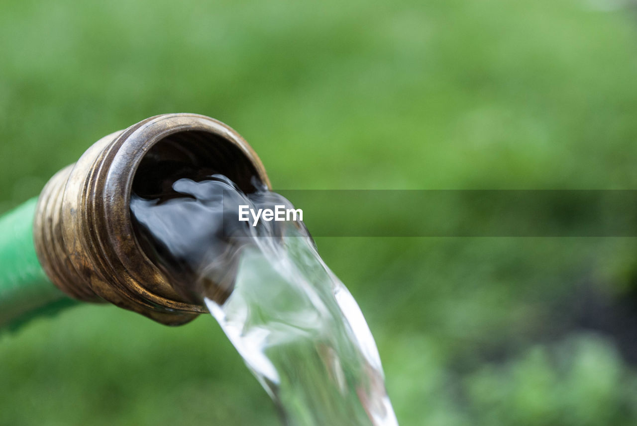 Close-up of water running from pipe