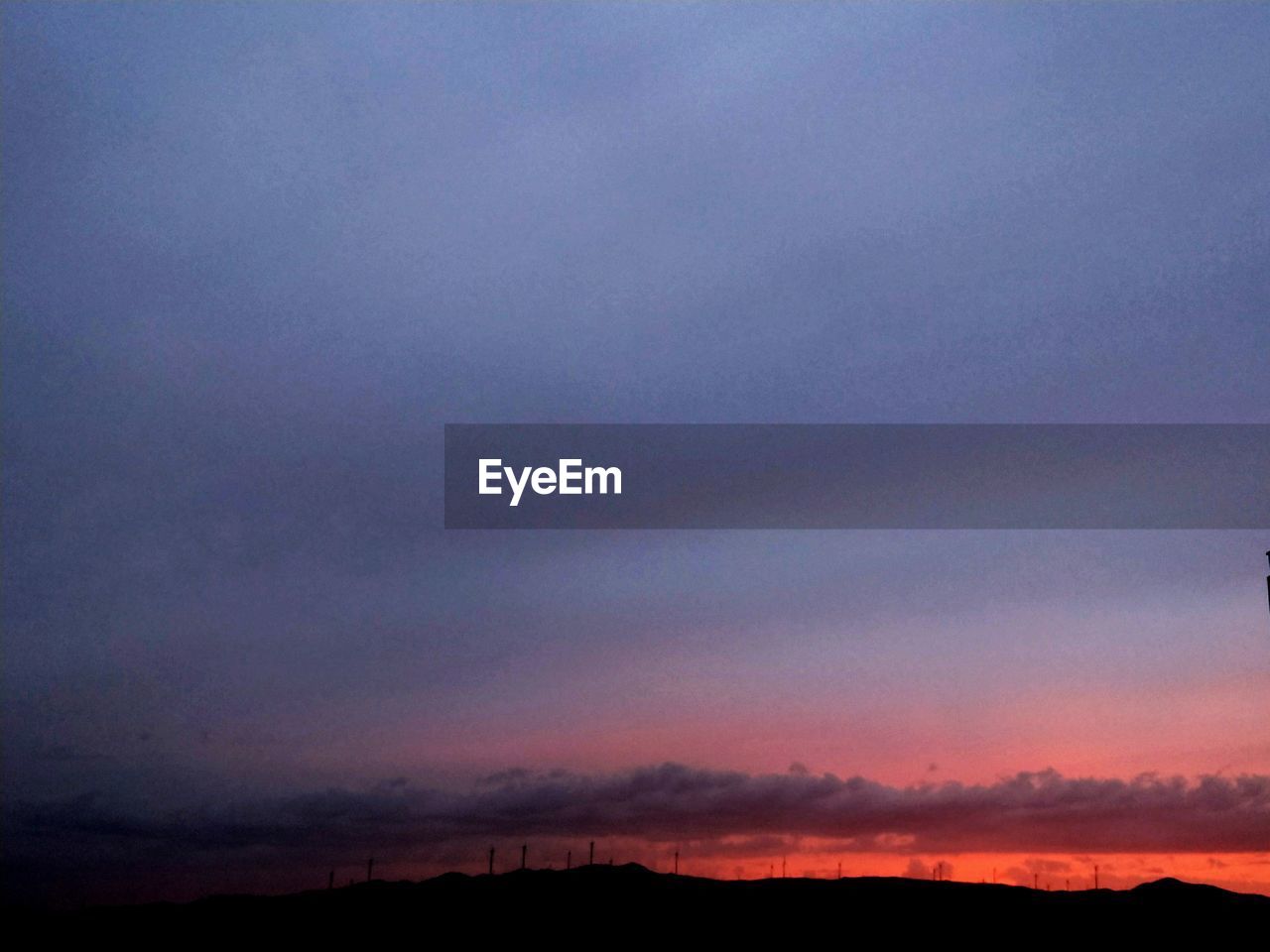 SILHOUETTE LANDSCAPE AGAINST DRAMATIC SKY