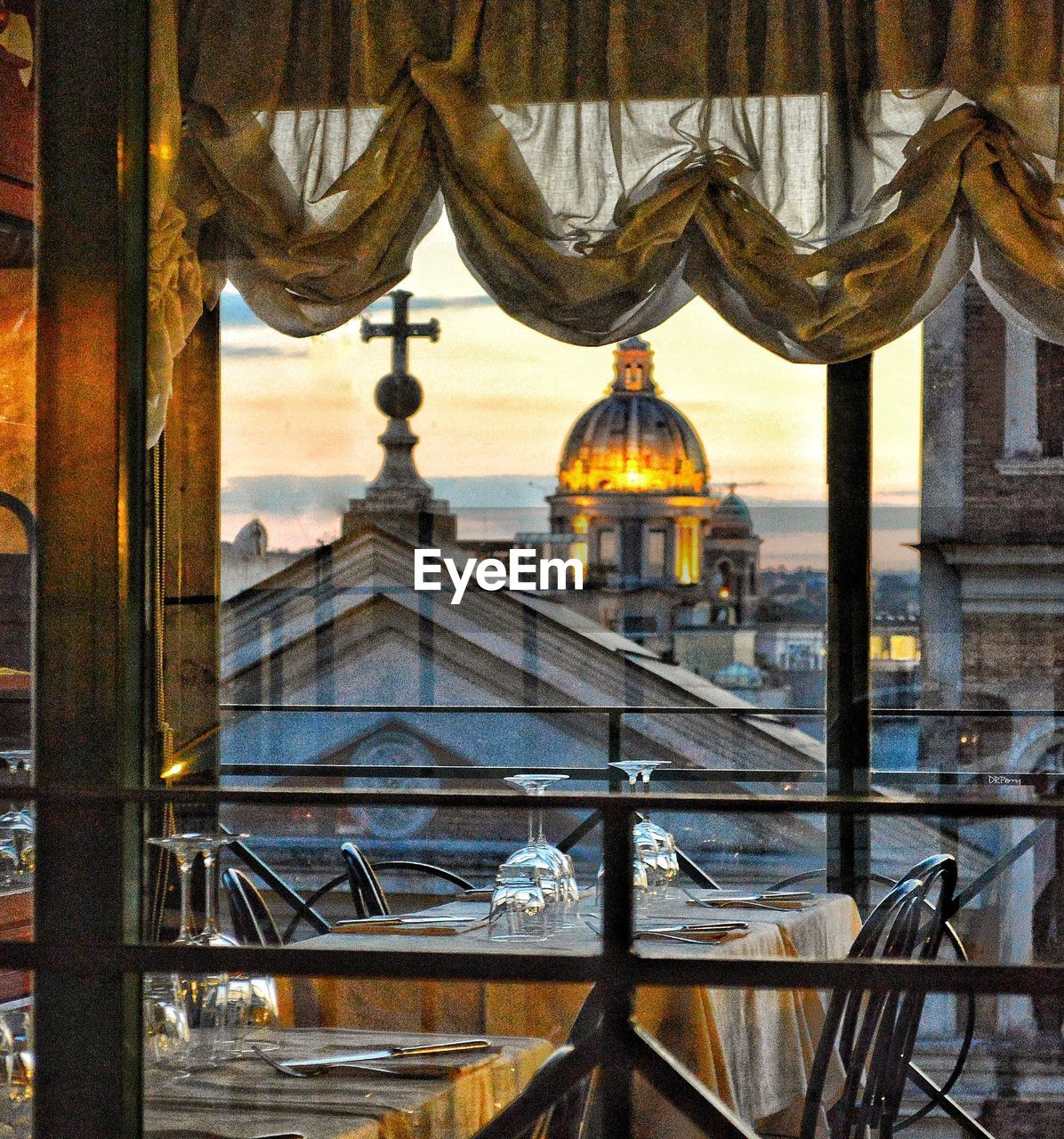 View of cathedral through window against buildings in city