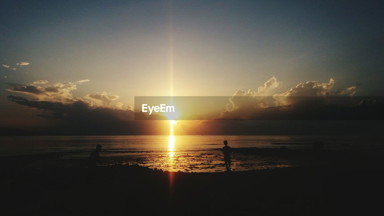 SILHOUETTE BEACH AGAINST SKY DURING SUNSET