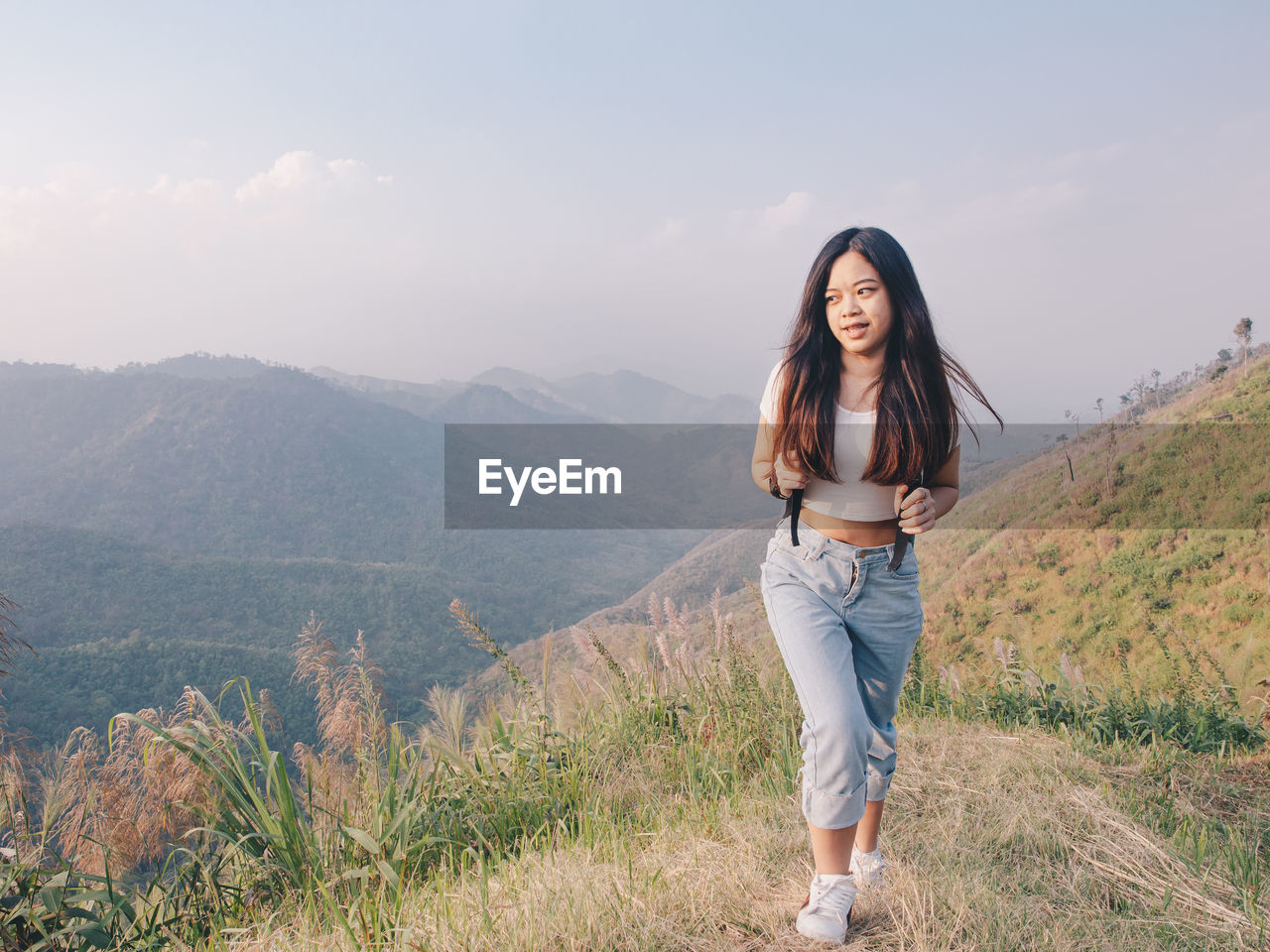 Wanderlust and travel concept from happy asian young woman walking trail in mountain