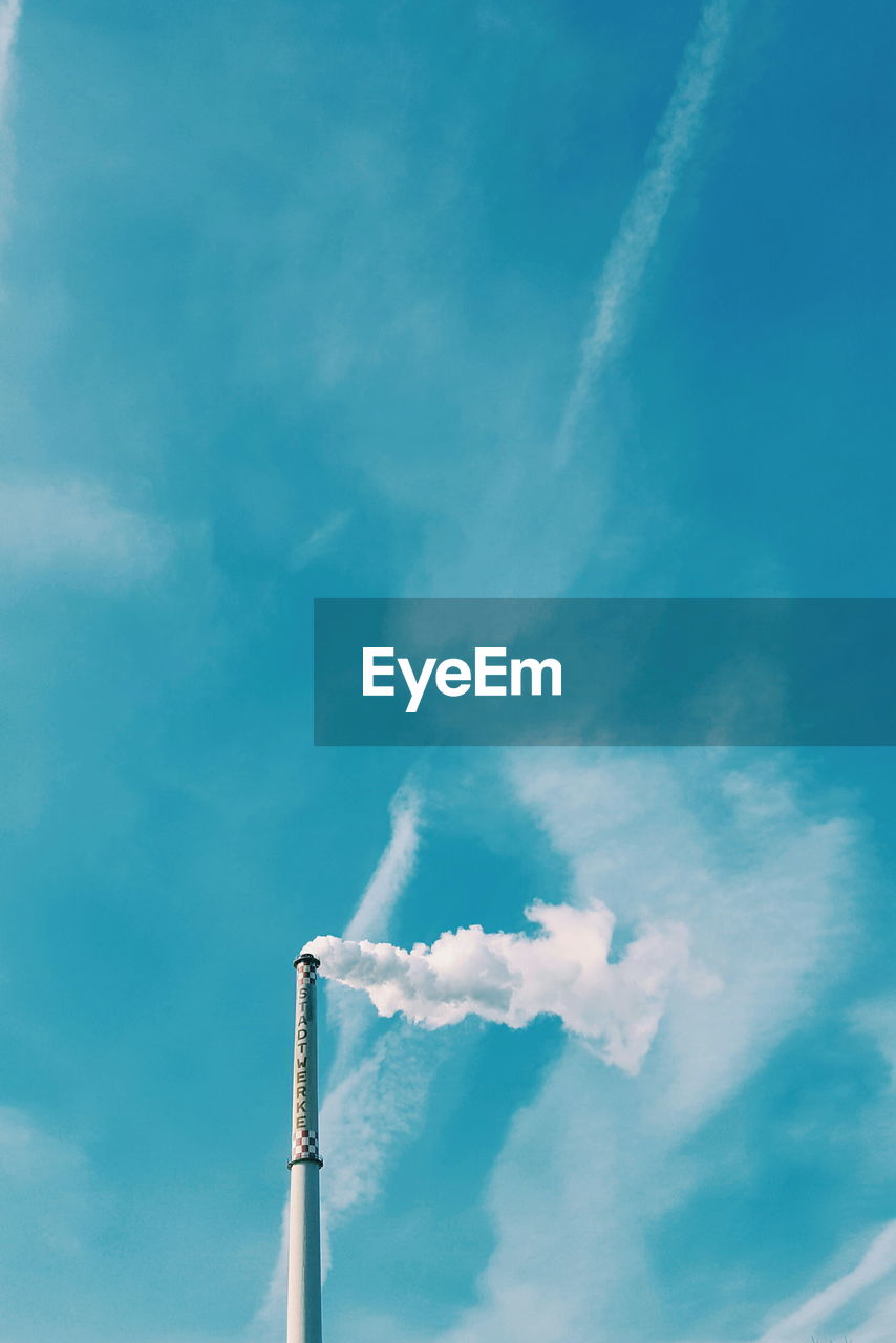 LOW ANGLE VIEW OF SMOKE STACKS AGAINST SKY