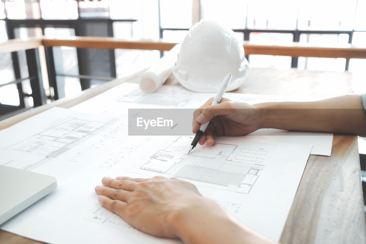 Cropped image of architect working at desk