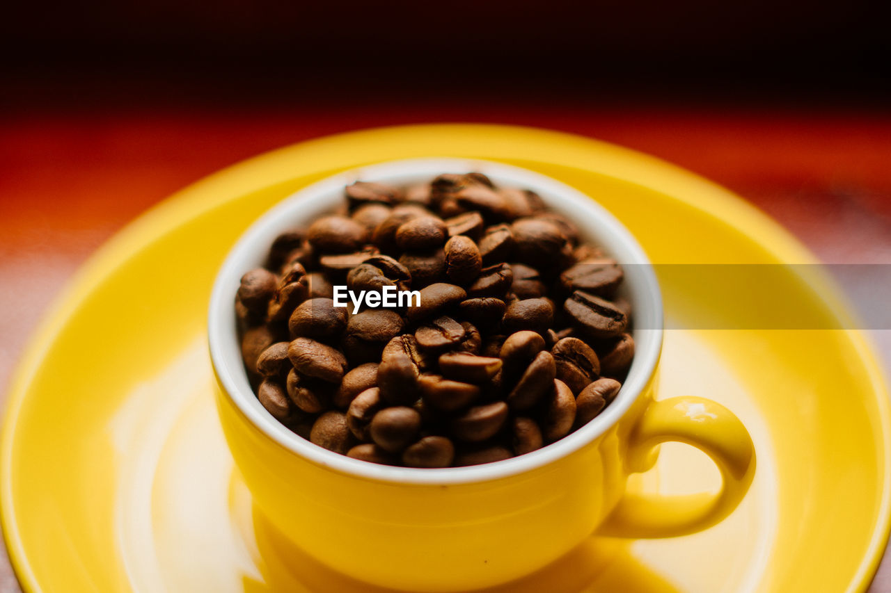 Close-up of roasted coffee beans on table