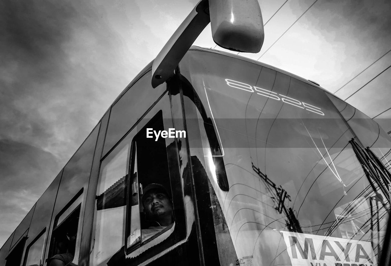 LOW ANGLE VIEW OF CARS AGAINST THE SKY