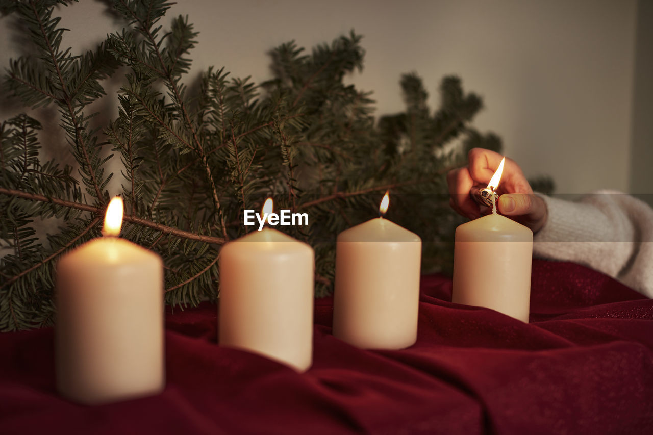 Hand lighting advent candle