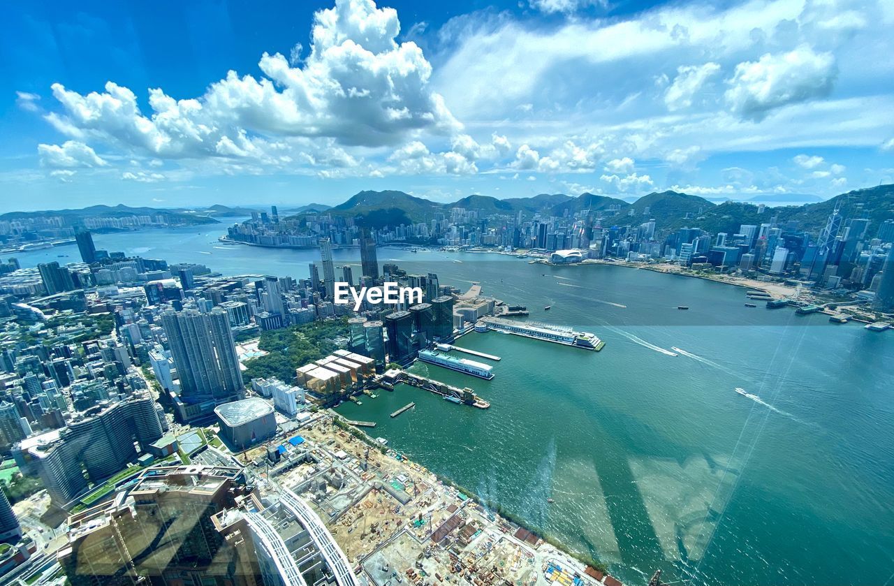 HIGH ANGLE VIEW OF BAY AND BUILDINGS AGAINST SKY