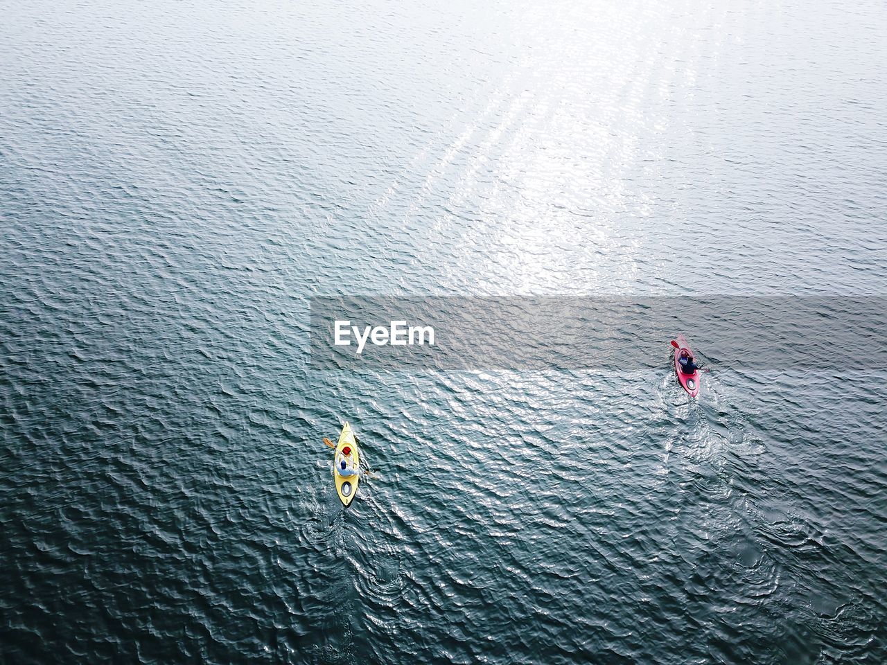 High angle view of people kayaking on lake
