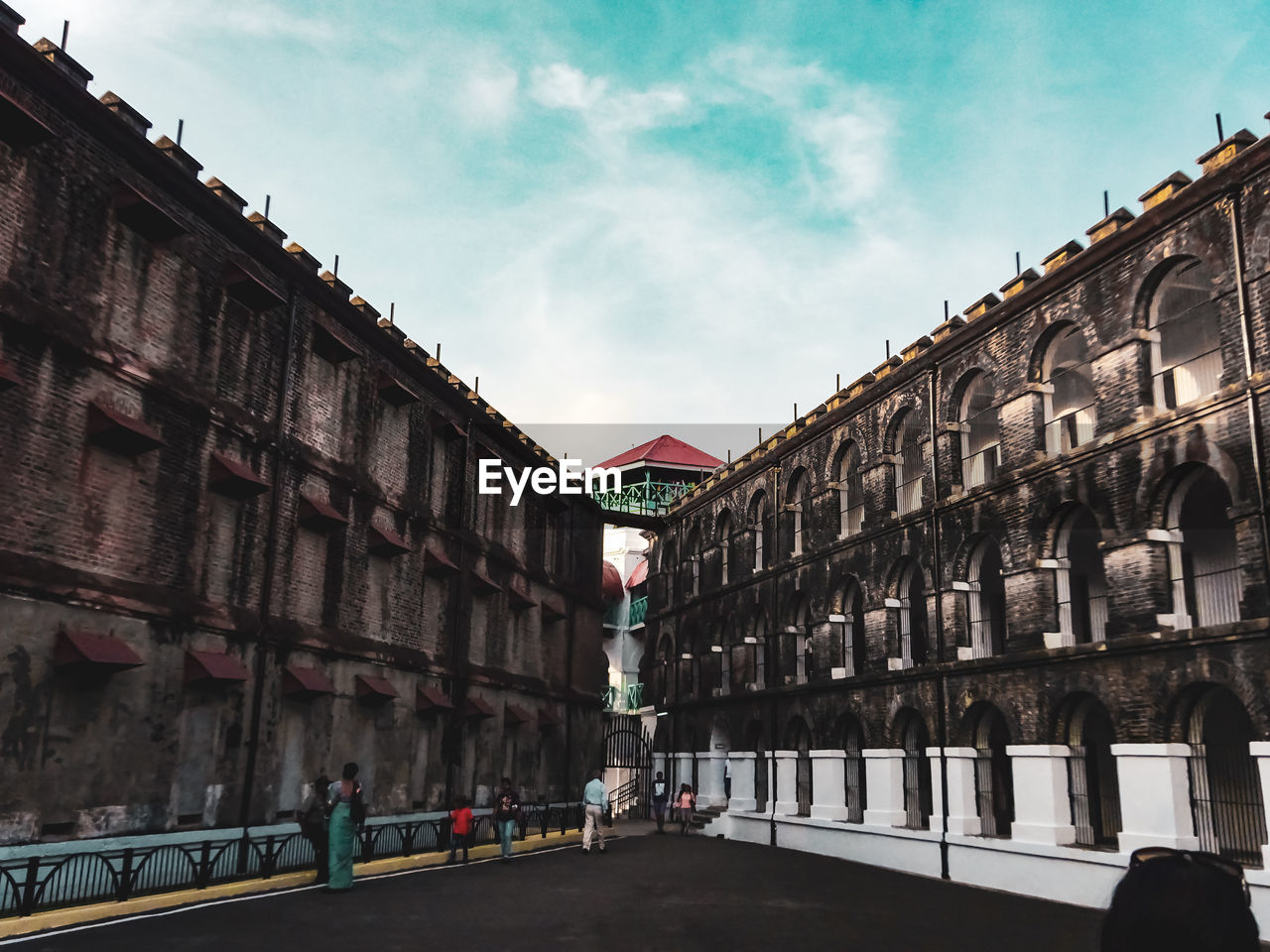 ROAD AMIDST BUILDINGS AGAINST SKY