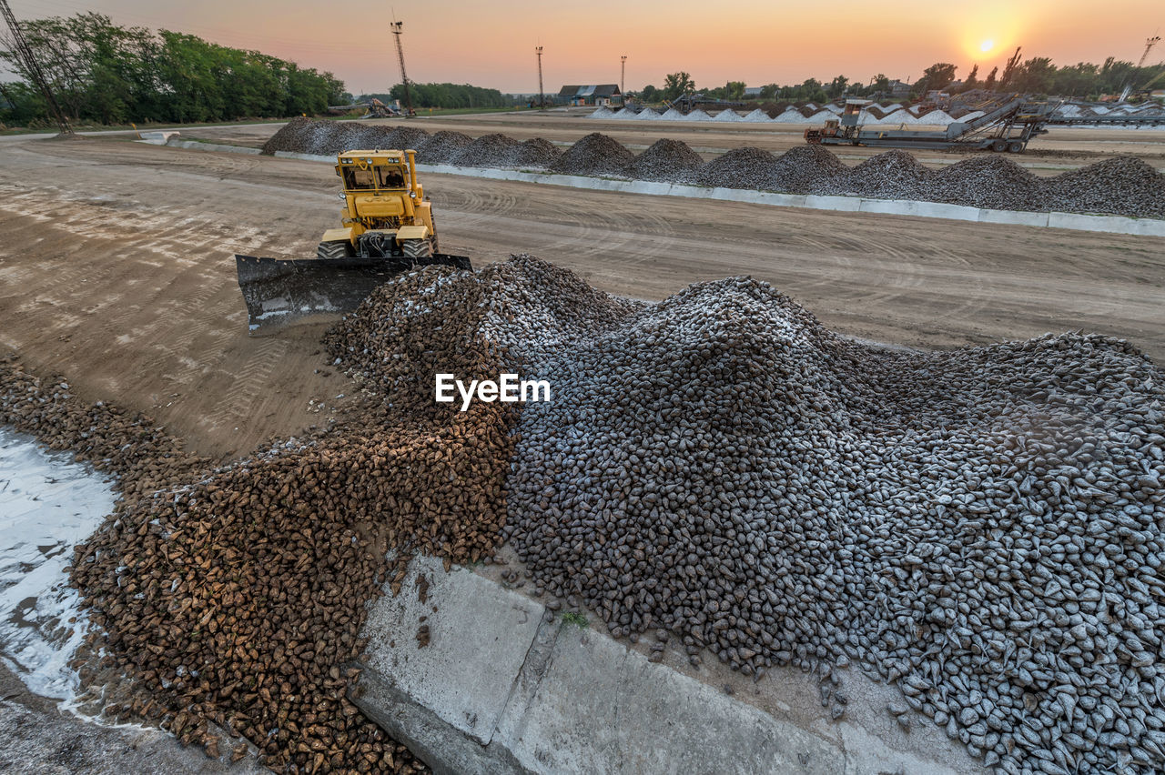 High angle view construction vehicle at site during sunset