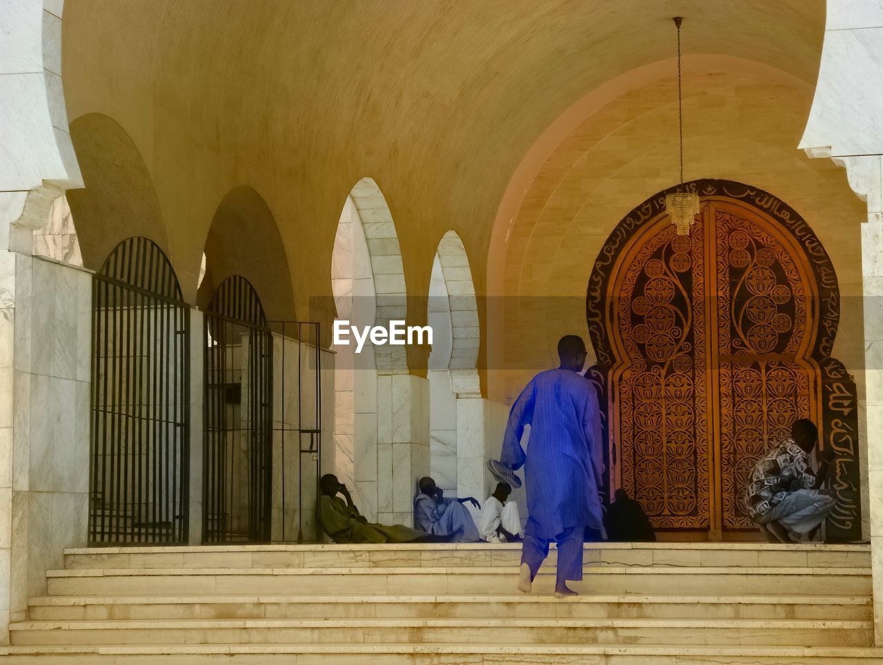 Islamic men waiting in front of the mosque in Senegal Praying Time Ceremony Islamic Tradition Walking On Stairs Mosques Of The World Architectural Detail Wooden Door Religious Building Religious Photography Religious People Believing Preaching At The Door Allah Door Allah Mosque Door Islam Islamic Architecture Building Exterior Traditional Clothing Place Of Worship Spirituality Belief Real People Building Built Structure Architecture Sitting On The Stairs Islamic Men Religion Religion Architecture Mosque Touba Great Mosque Of Touba Amadou Bamba Mouride Bamba Pilgrimage Site Pilgrimage Grand Magal Of Toub