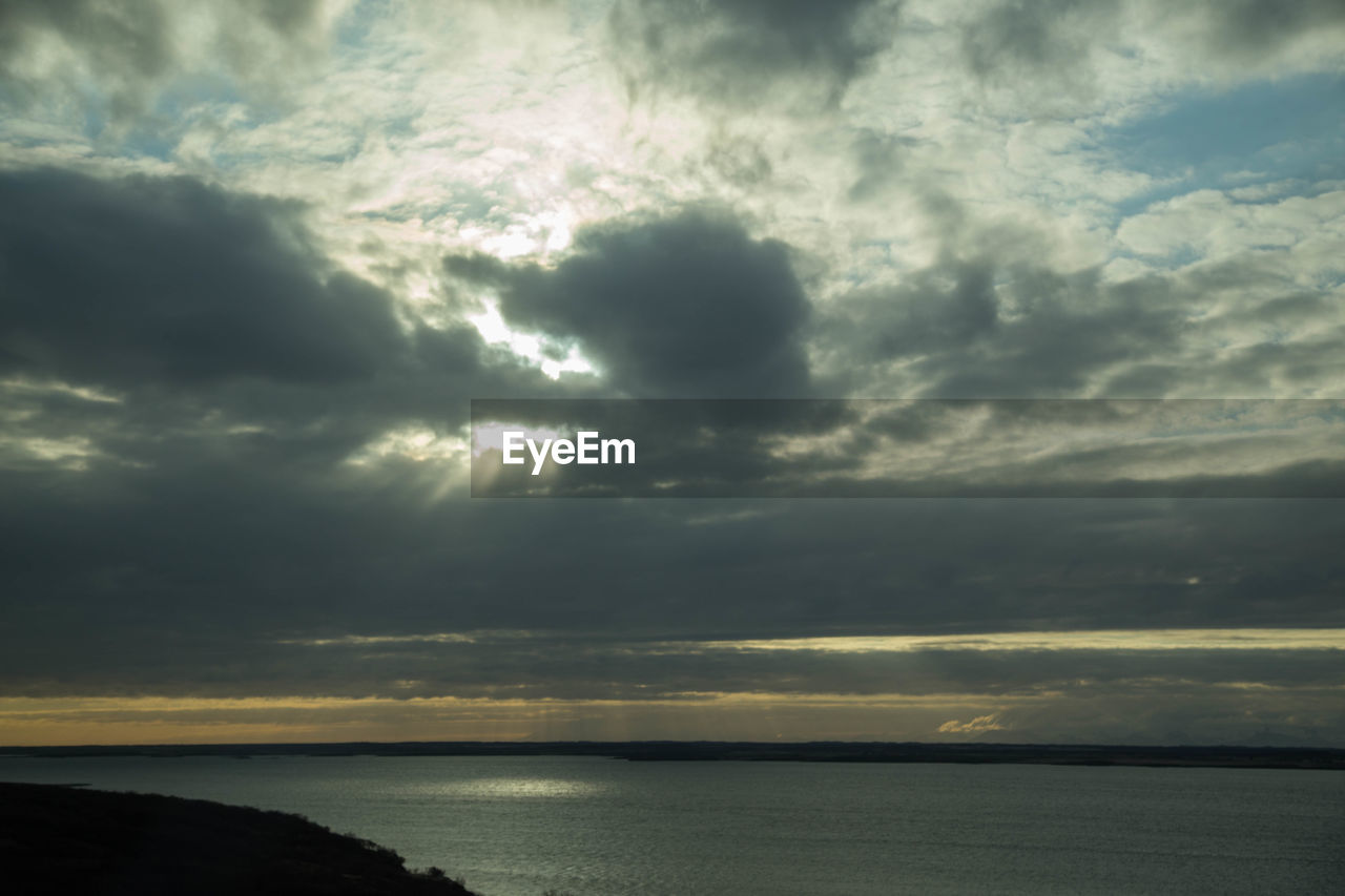 Scenic view of sea against dramatic sky