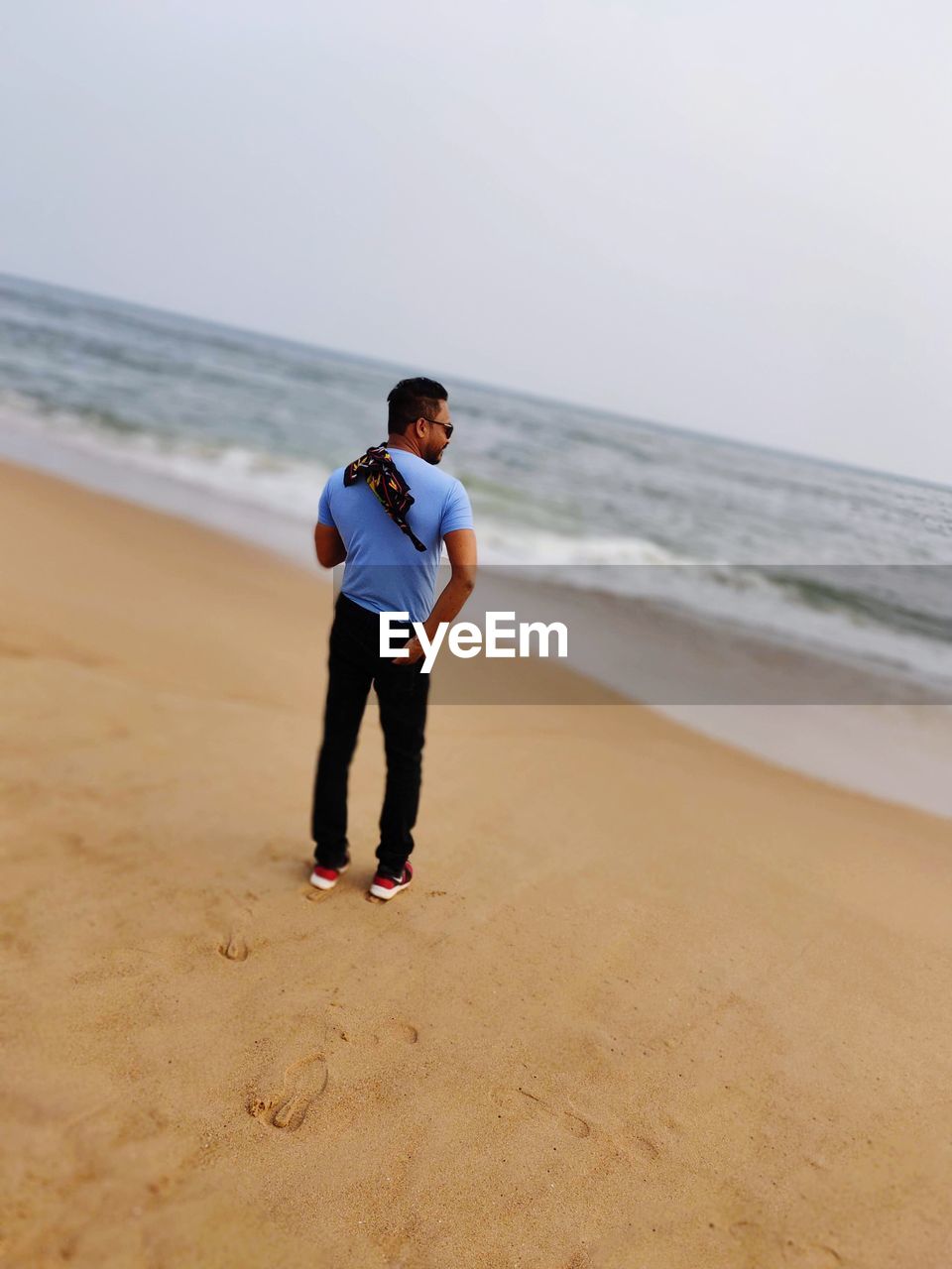 FULL LENGTH OF BOY STANDING ON BEACH