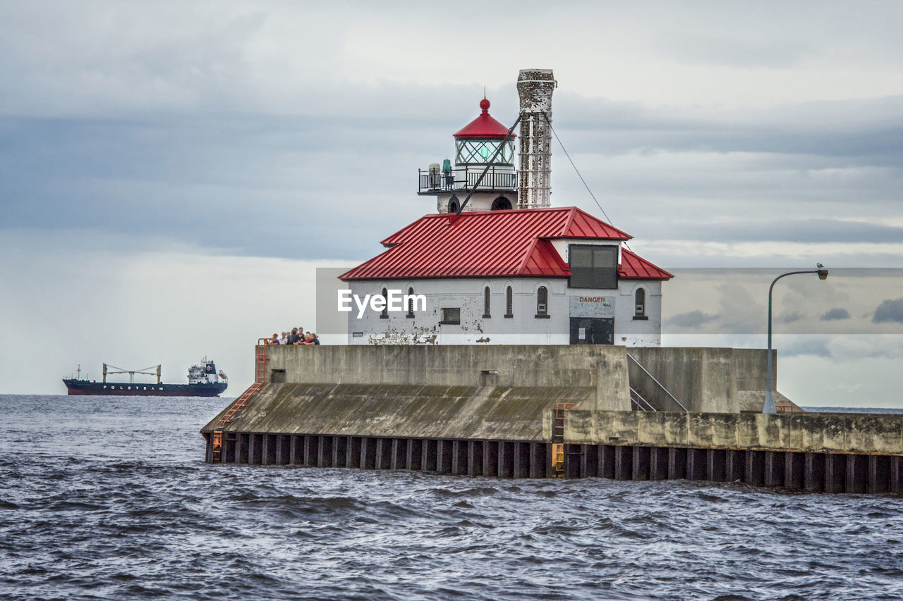 BUILT STRUCTURE ON SEA AGAINST SKY