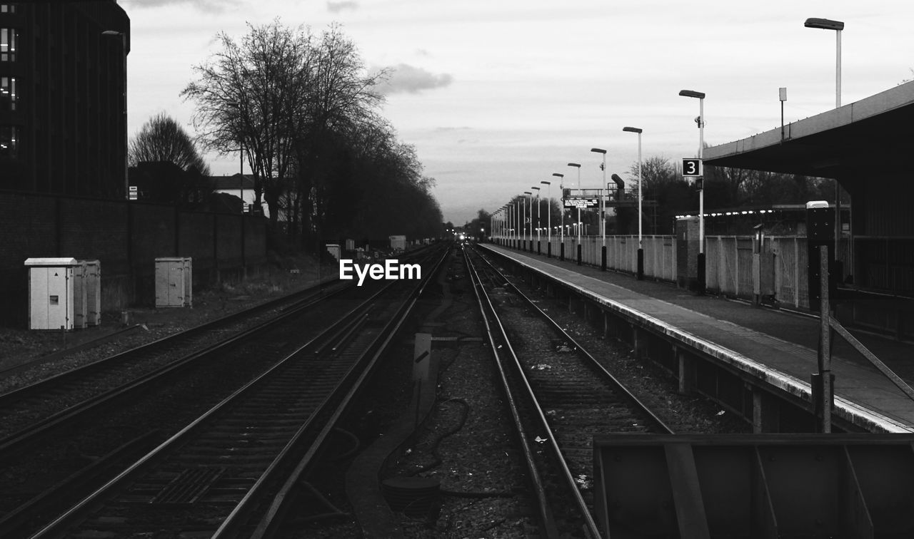 Railroad track against cloudy sky