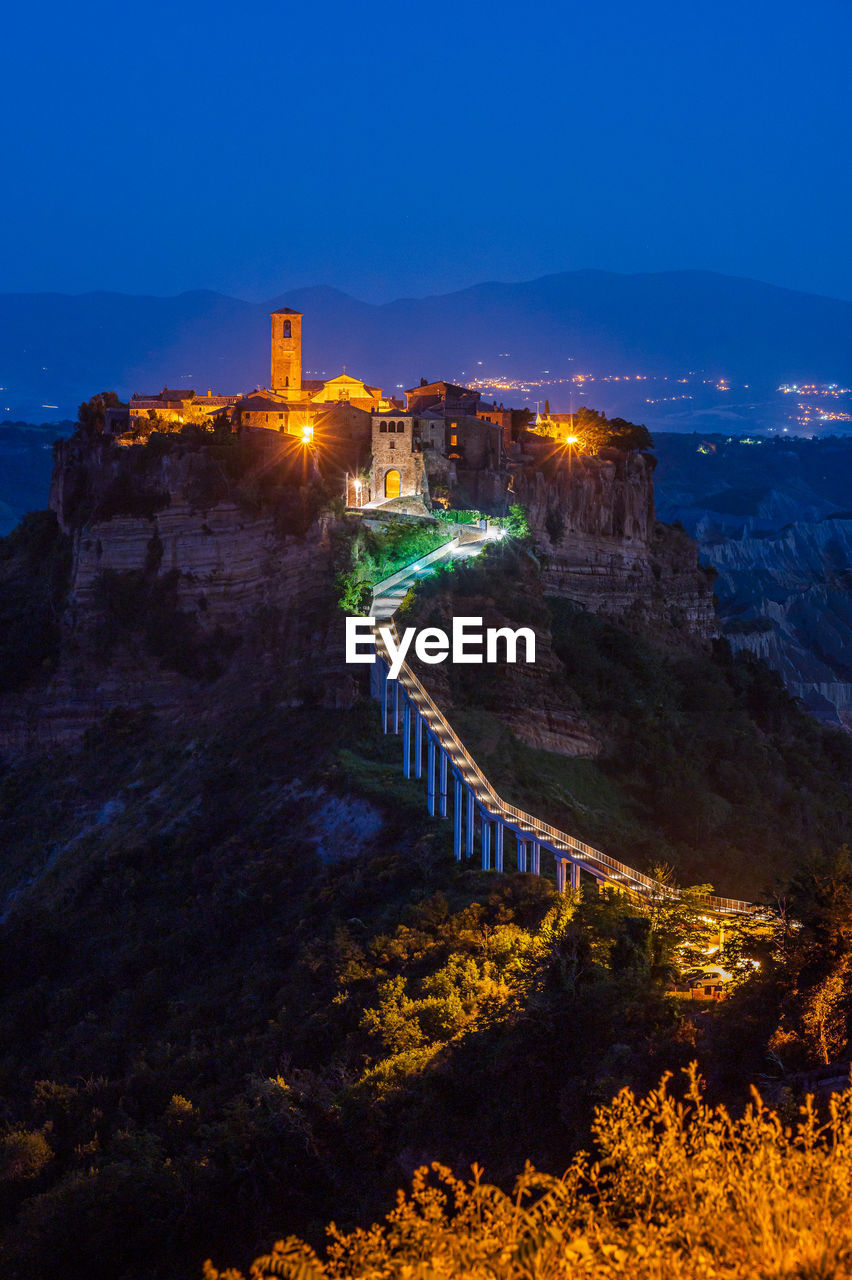 The ancient village of civita di bagnoregio, also called the diying city, in italy, at the blue hour