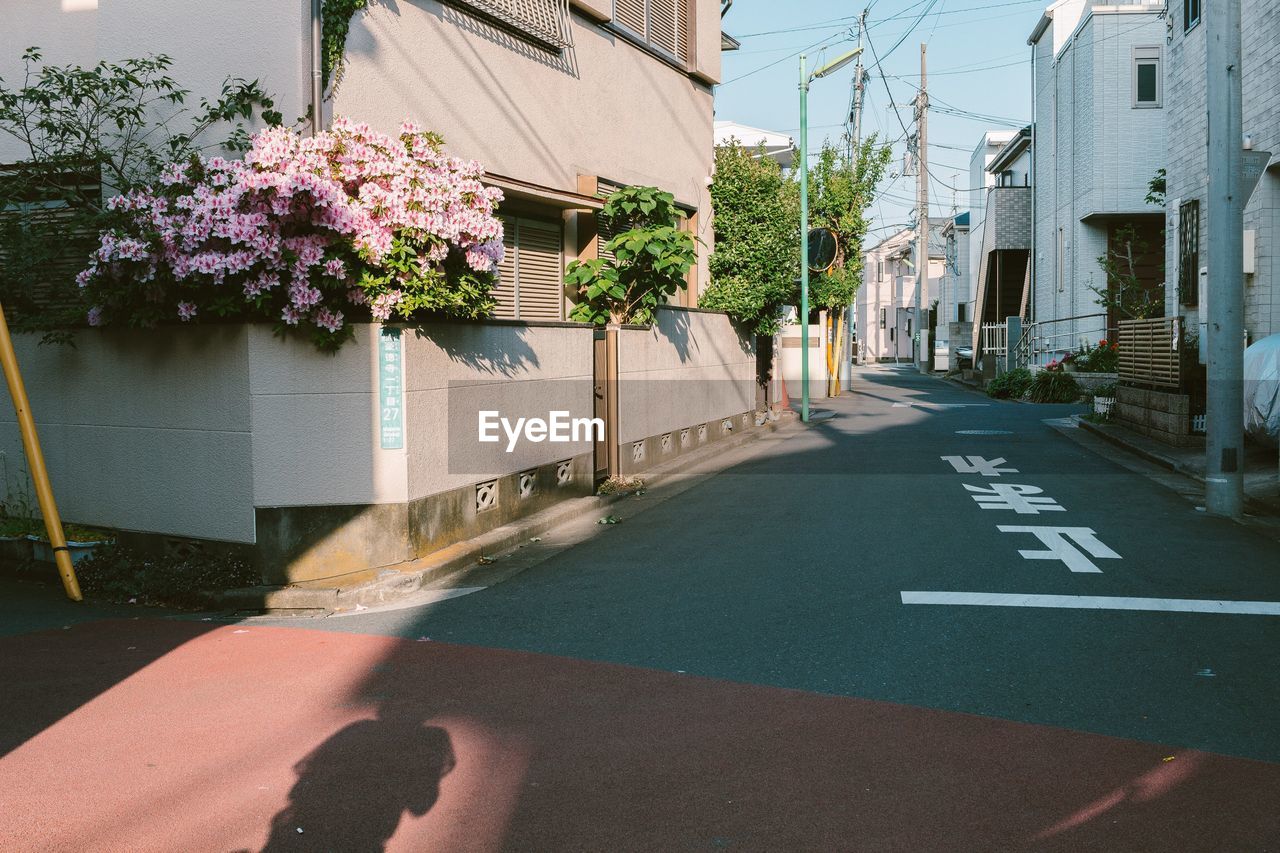 Road amidst buildings in tokyo in the evening