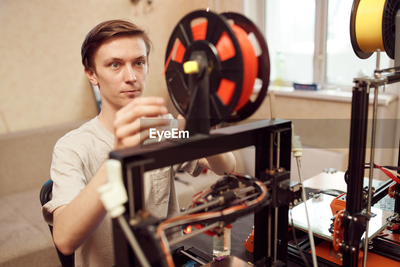 Portrait of young man holding camera