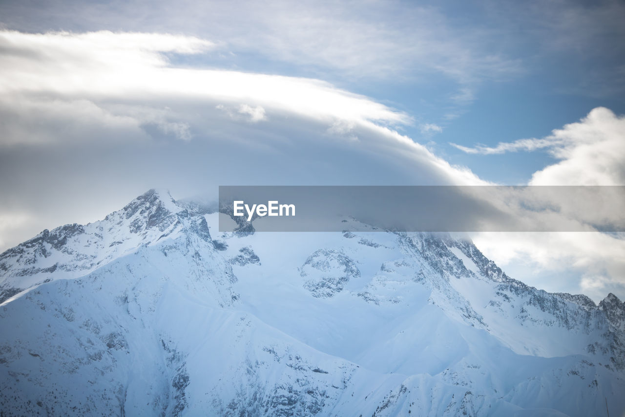 Scenic view of snowcapped mountains against sky