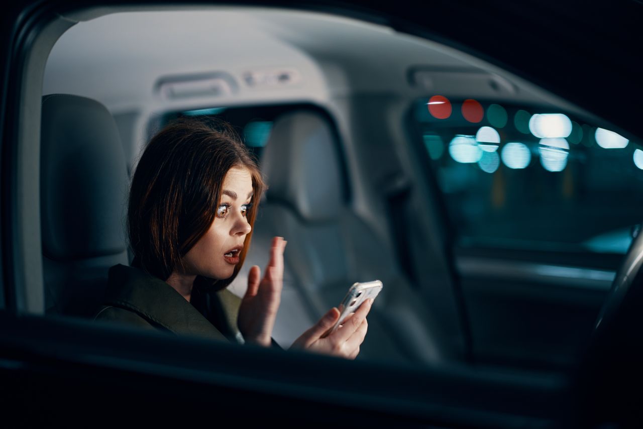 side view of young woman in car