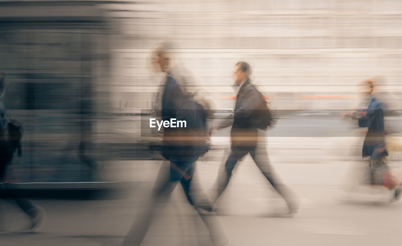 Blurred motion of people walking in city