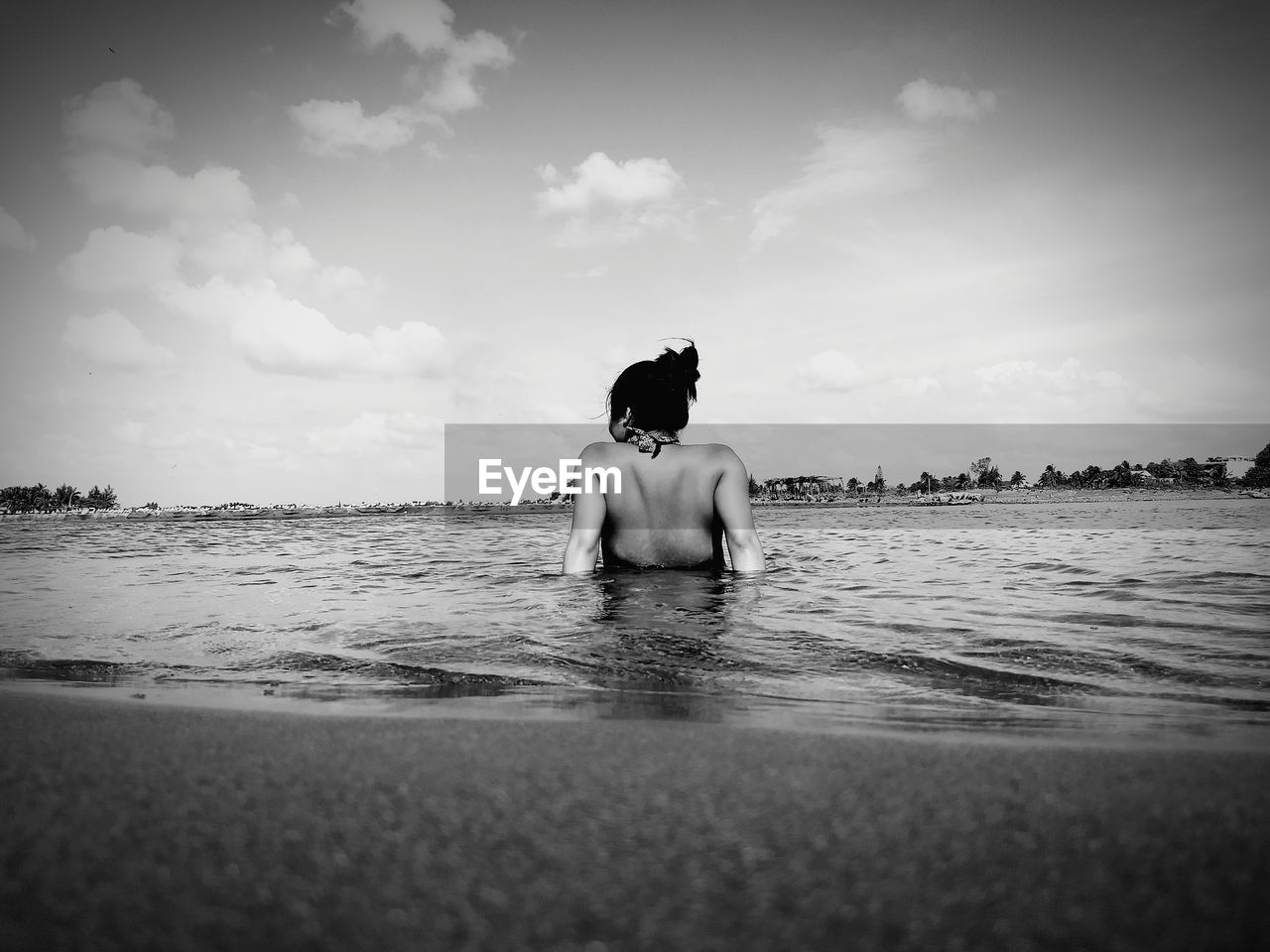 Woman swimming in lake against sky