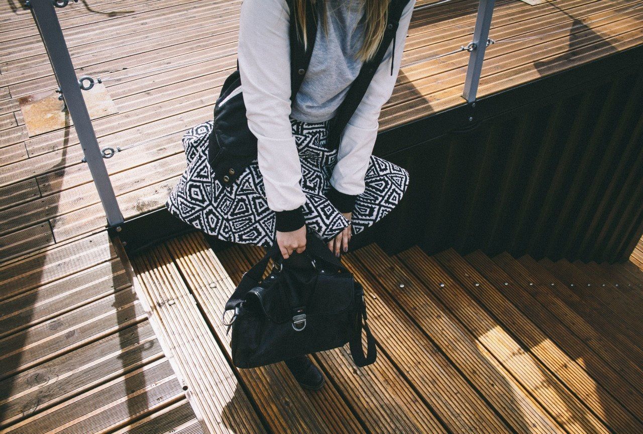 Low section of woman standing on wooden stairs