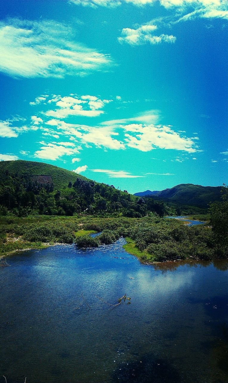 View of lake and hills against sky