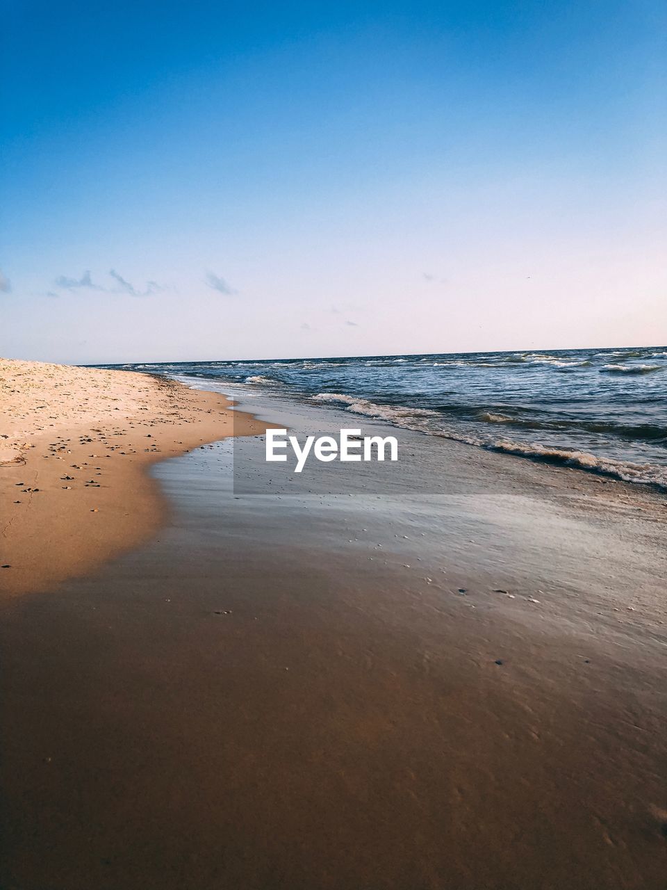 Scenic view of beach against clear sky