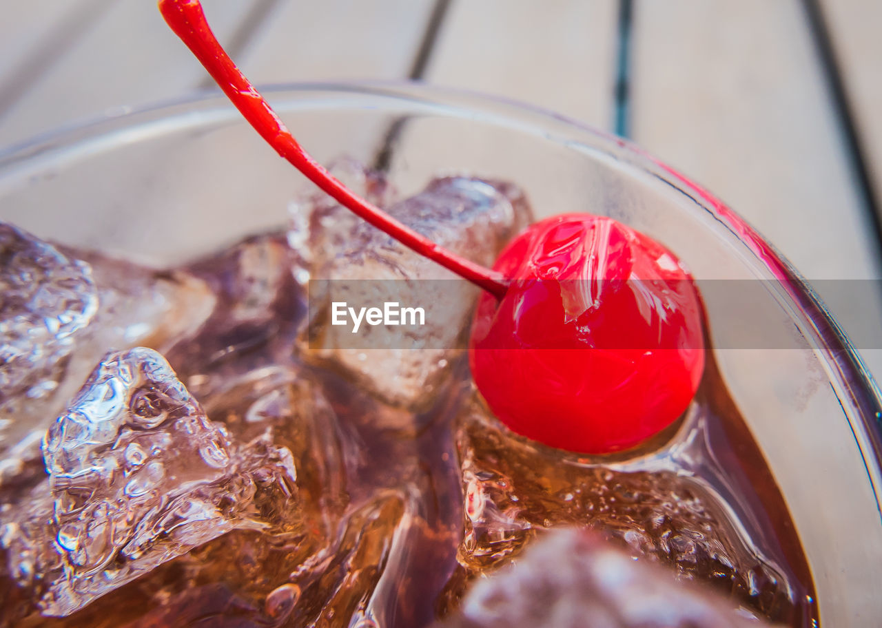 Close-up of cherry in cocktail glass