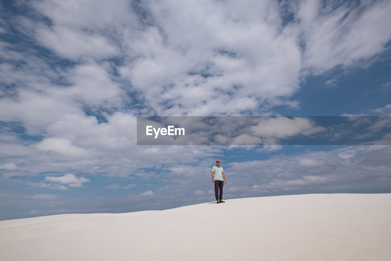 Full length of man standing on desert against sky