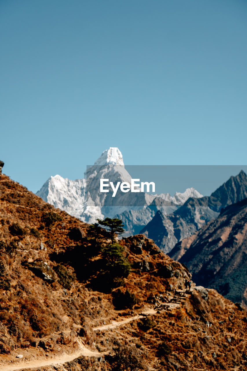 Scenic view of snowcapped mountains against clear sky