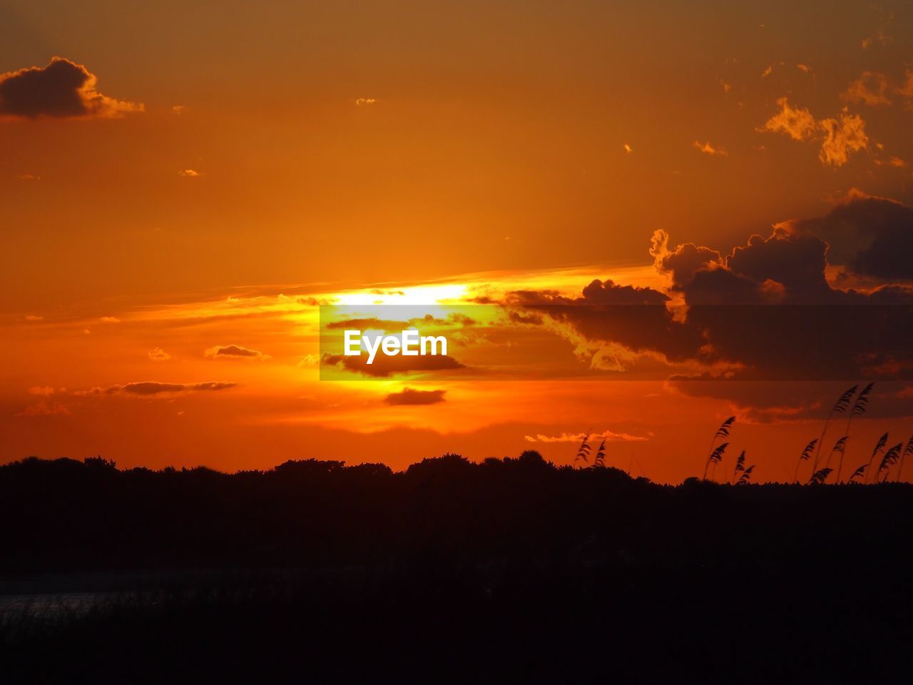 SCENIC VIEW OF DRAMATIC SKY OVER SILHOUETTE LANDSCAPE DURING SUNSET