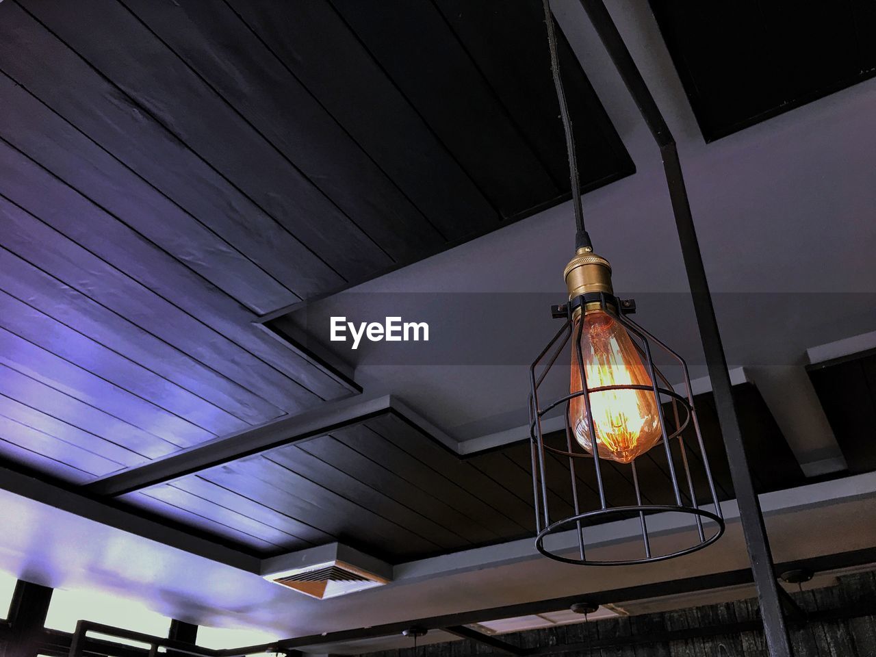 LOW ANGLE VIEW OF ILLUMINATED PENDANT LIGHT