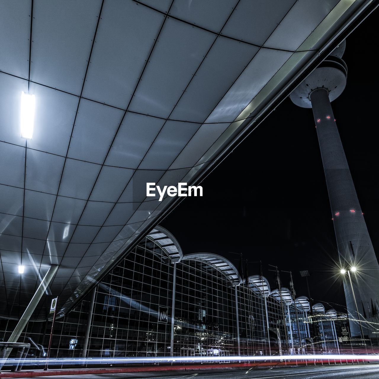 LOW ANGLE VIEW OF ILLUMINATED BRIDGE AT NIGHT