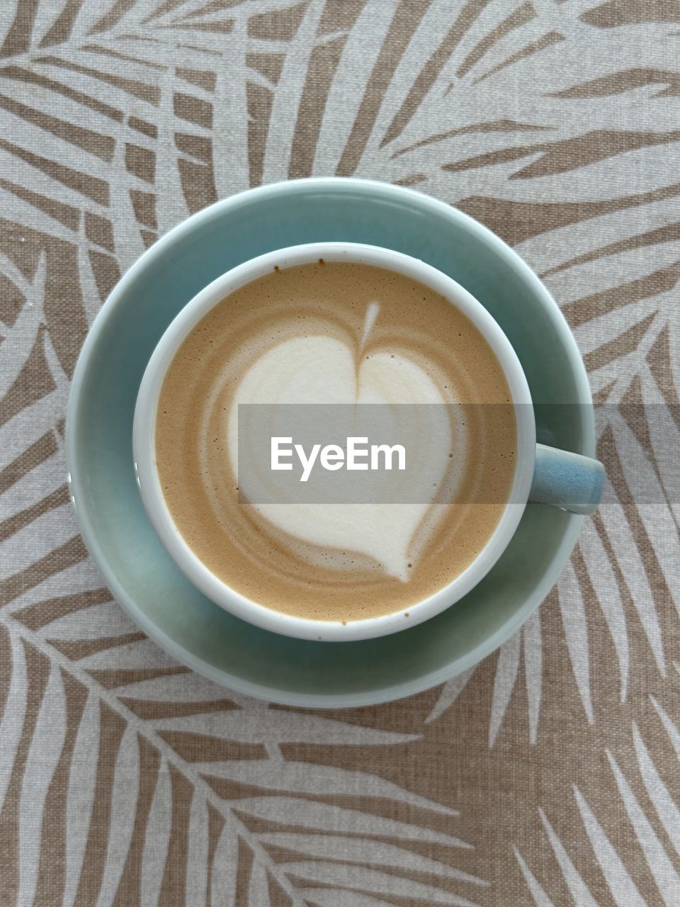 cup, drink, mug, coffee, food and drink, refreshment, coffee cup, hot drink, still life, table, directly above, pattern, indoors, high angle view, crockery, saucer, no people, frothy drink, freshness, close-up, cappuccino, latte, froth art, coffee milk, food, tablecloth