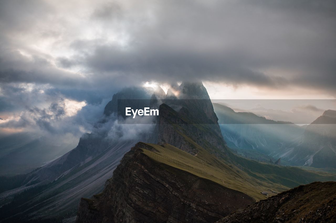 Scenic view of mountains against cloudy sky