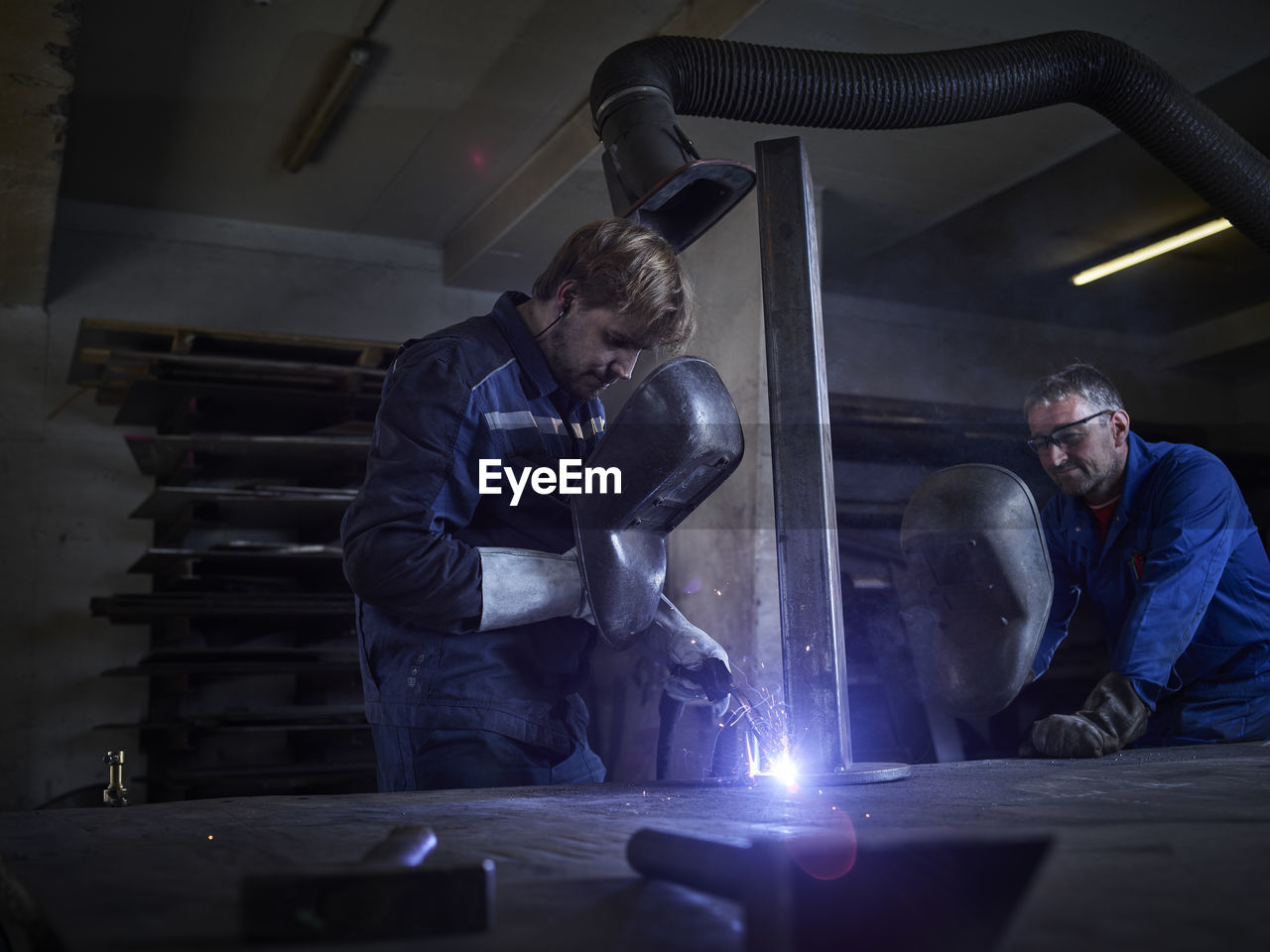 Worker welding in factory