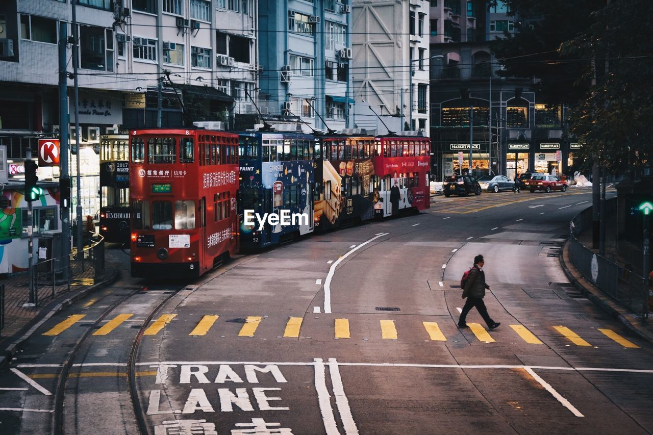 MAN ON ROAD ALONG BUILDINGS